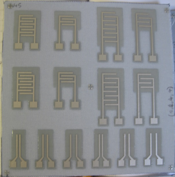 Printed multilayer PCB on fabric with vias.